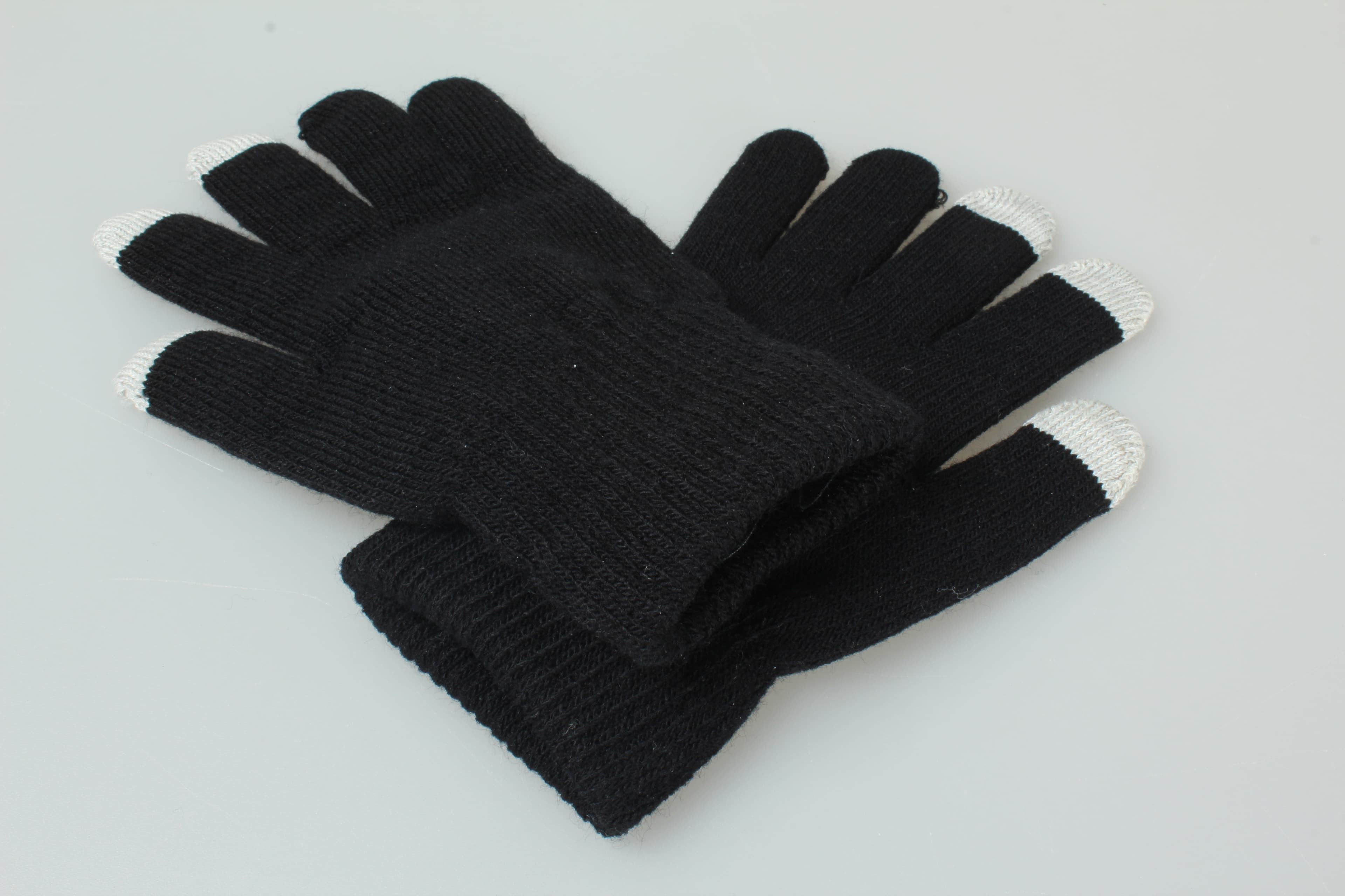 One pair of black knit gloves with light-coloured touchscreen fingertips